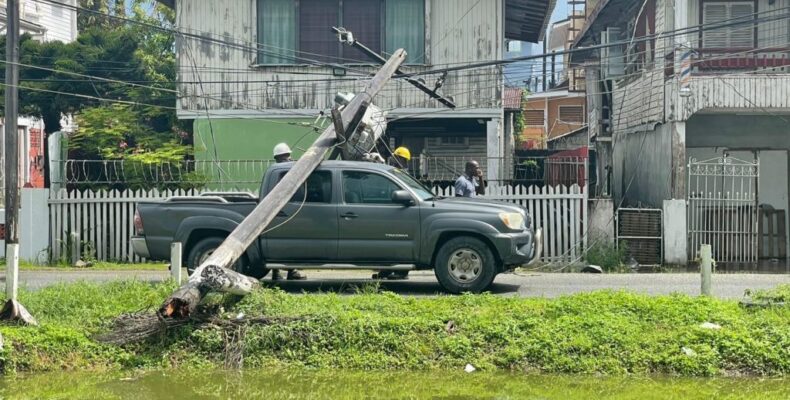 Workers escape unharmed after electrical pole falls on vehicle